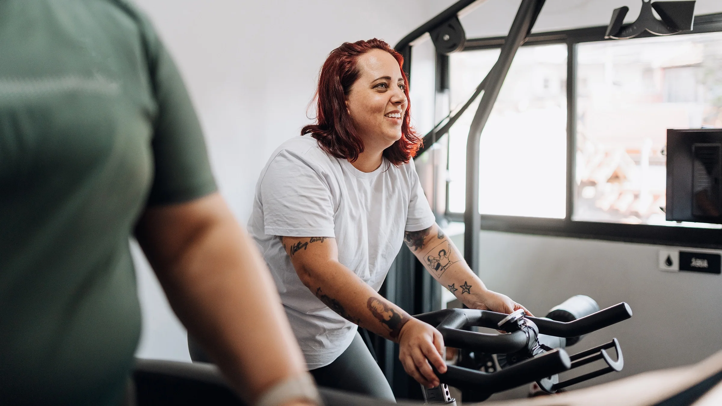 Woman working out on a stationary bike at the gym