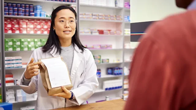 Medication Education: Pharmacy: pharmacist handing a prescription 1484915232