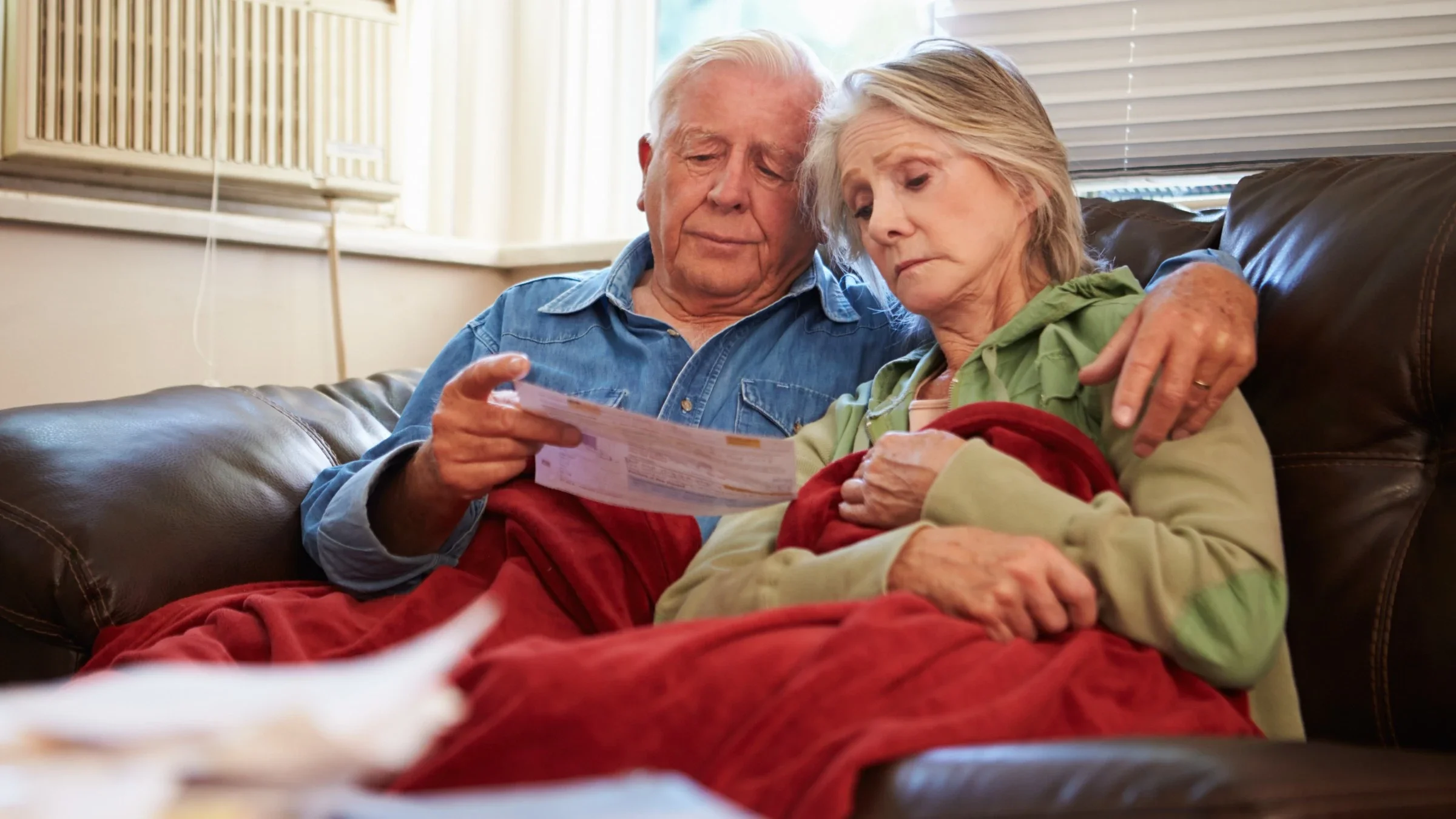A concerned senior couple examining a bill.