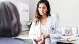 A healthcare professional is pictured speaking to a patient.
SDI Productions/E+ via Getty Images 