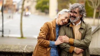 Medicare: couple embracing outdoors 2208612382