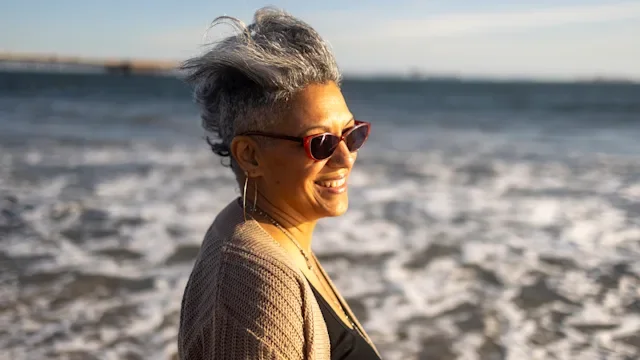 fsa-hsa: beach: vision: person: older woman at beach with sunglasses-1316489948