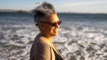 fsa-hsa: beach: vision: person: older woman at beach with sunglasses-1316489948