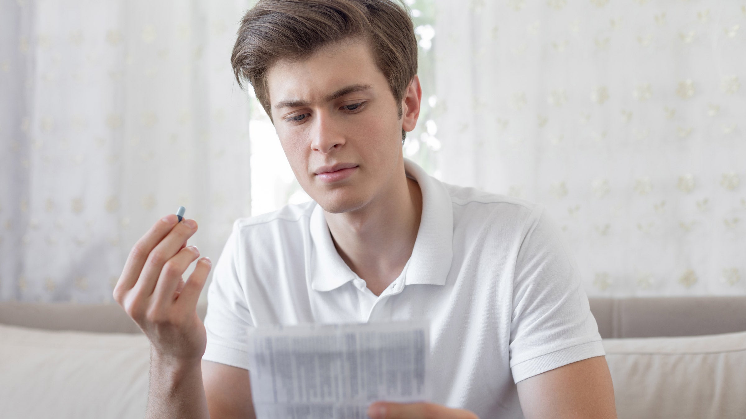 Smoking cessation: Pill: 	holding-pill-reading-label-1188225988.jpg