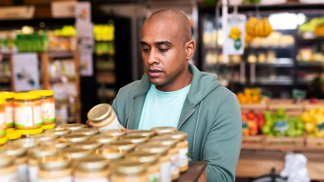 Diet nutrition: man reading food label 1300141883