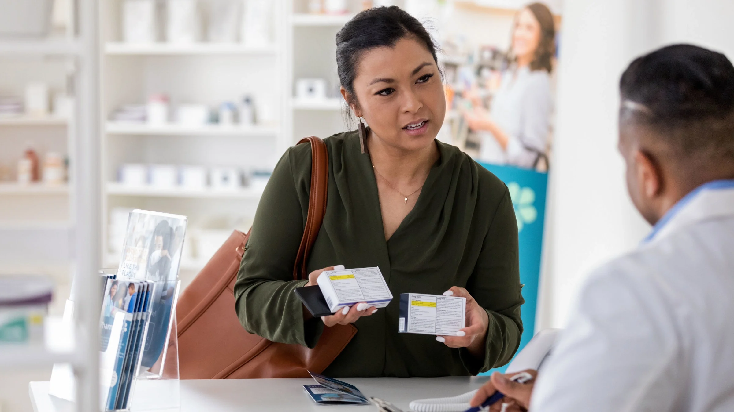 A  woman asks a pharmacist questions about a medication.