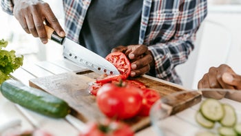diet-nutrition: closeup slicing tomato 2178750767