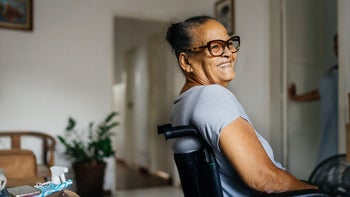 Health: Senior health: senior woman smiling in wheelchair-1325325651