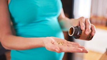 Health: Pregnancy: close up pregnant woman pill capsules-611890256