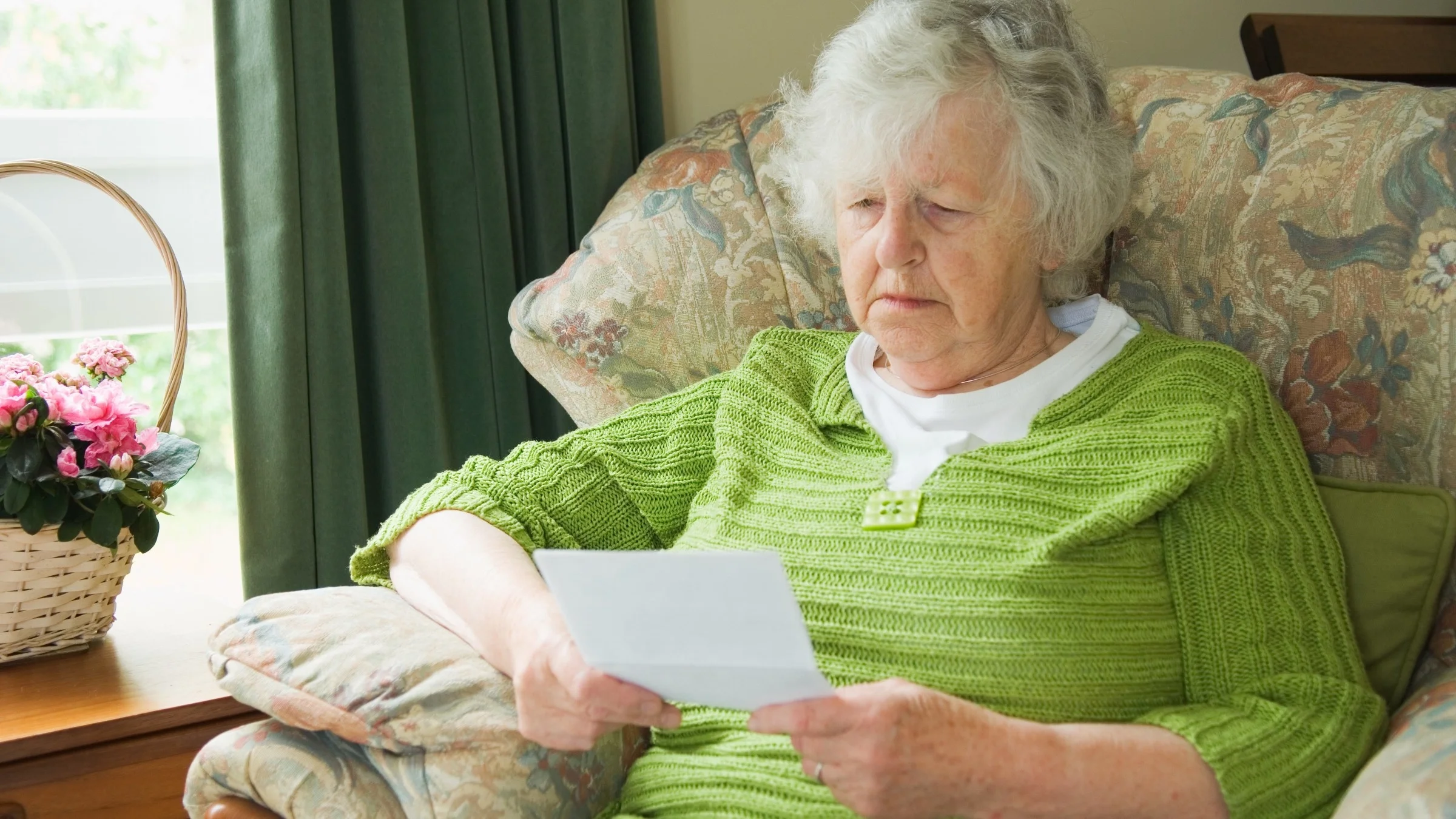 A senior adult reading a notice.
