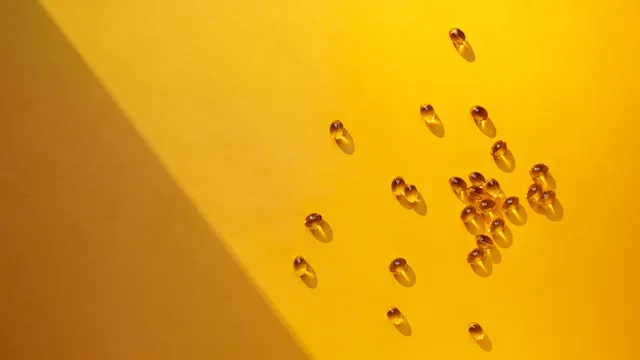 Supplements and Herbs: vitamins on yellow surface 1258232578