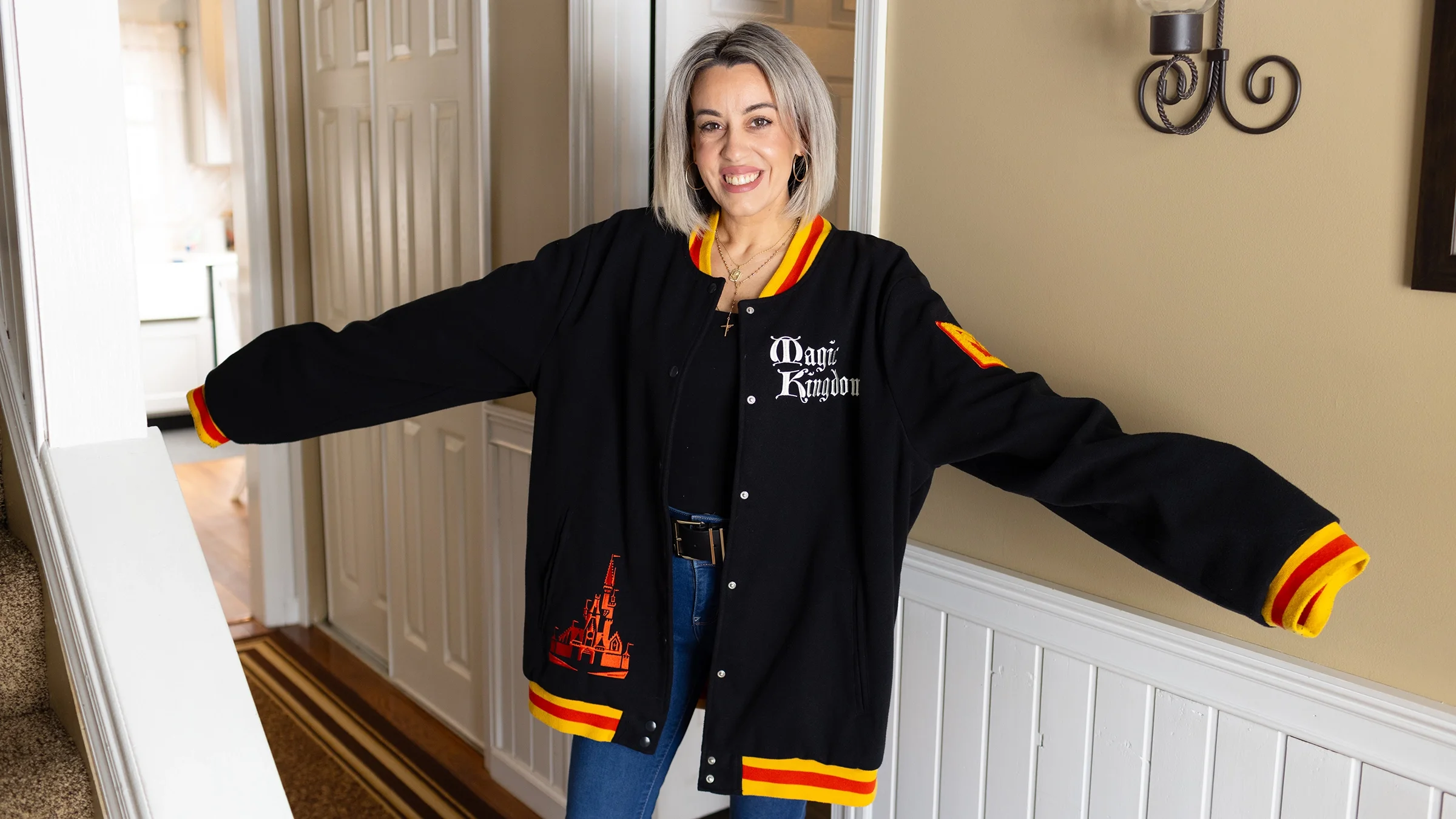 Kat Carollo poses with her old size 20 jacket. She is currently a size 6. 