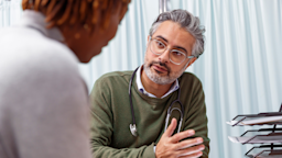 A healthcare professional consults with a patient in a medical office.
Fly View Productions/E+ via Getty Images