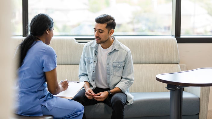 A man speaks to a healthcare professional.
