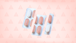 In the center of a light pink peach colored background with texture and warning sign pattern is a blister pack of white and peach colored pills. 
GoodRx Health