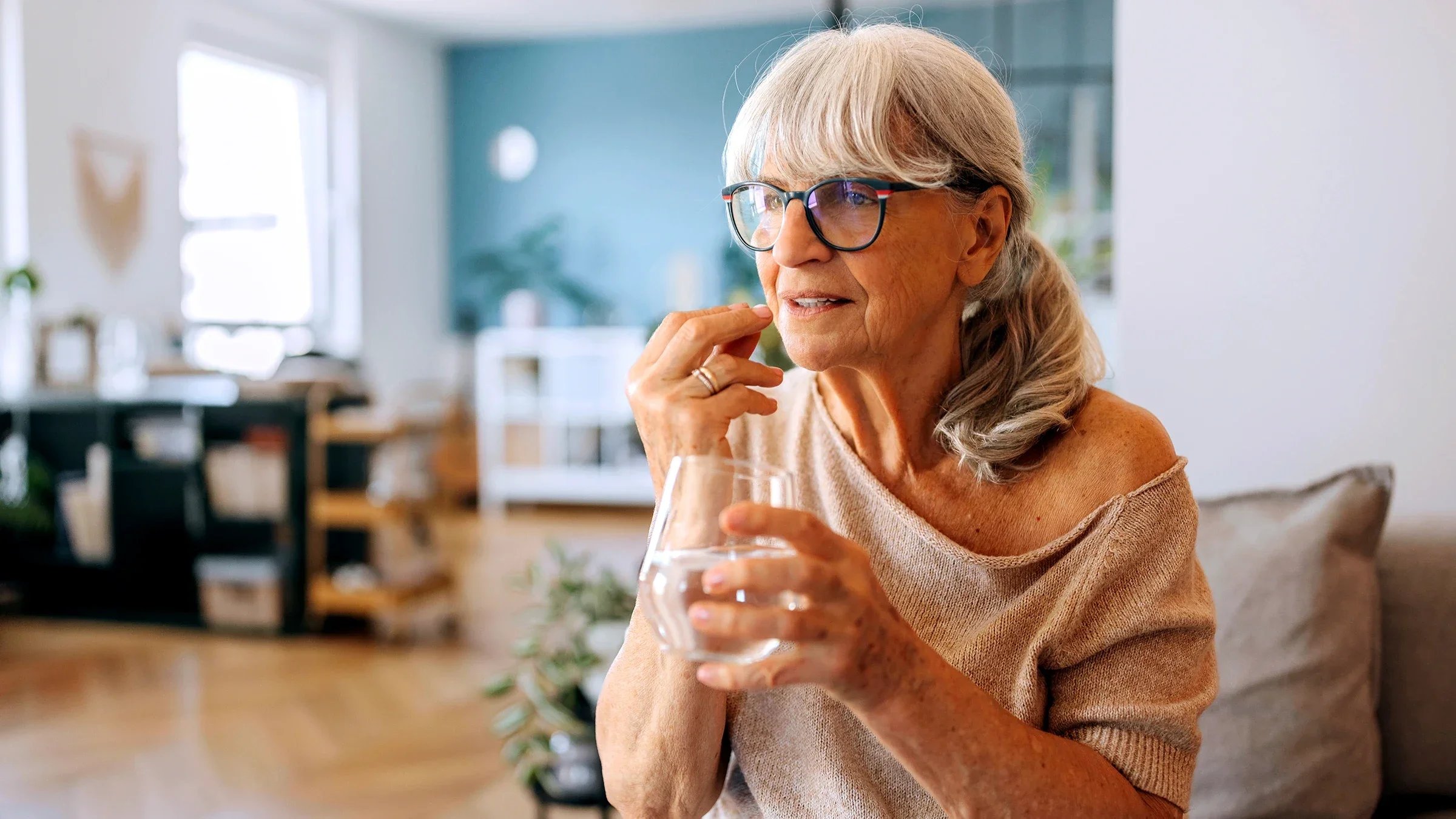 A woman is taking a pill with water.
Fuse Img/E+ via Getty Images