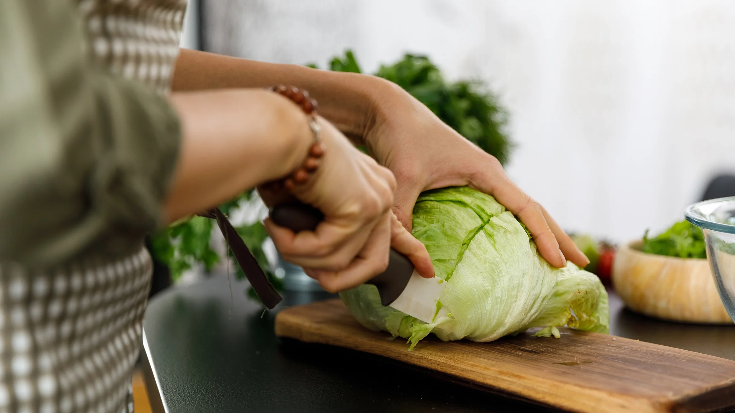 Close-up of chopping a head of iceberg lettuce