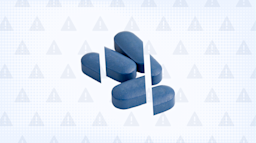 Light blue background with texture and warning sign pattern. In the center is a pile of dark blue pills cut into thirds. 
GoodRx Health