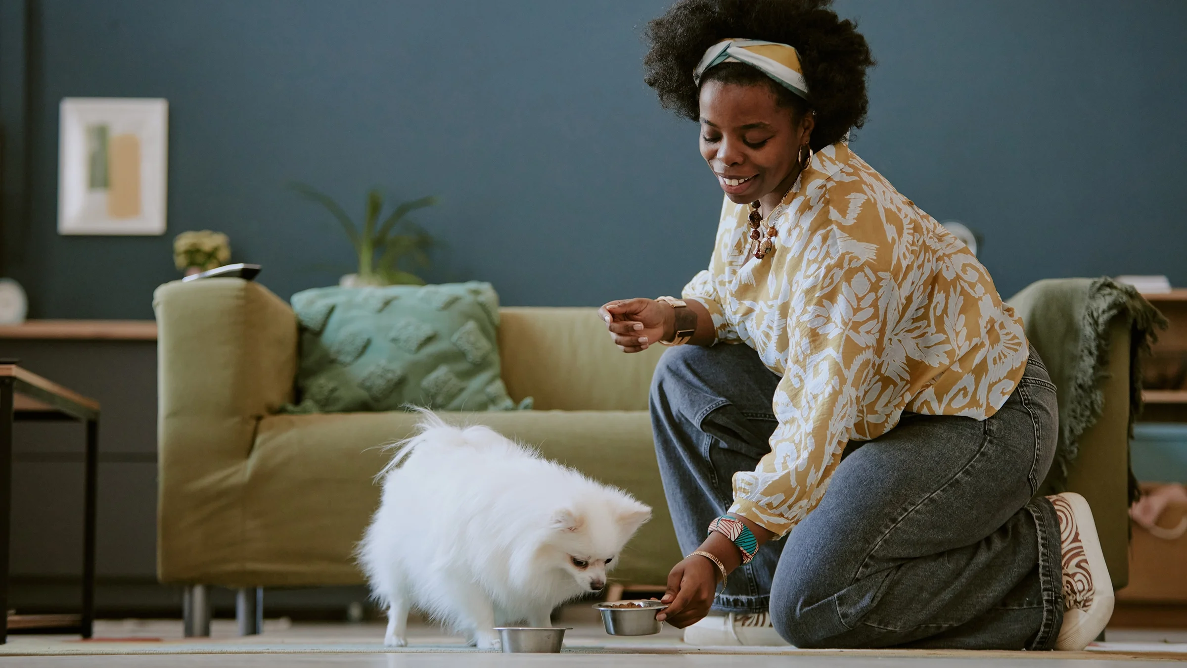 Woman feeding her dog.
