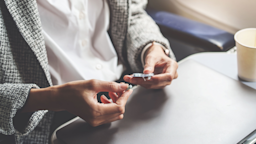 A woman takes medication on an airplane.
Jirapong Manustrong/Getty Images
