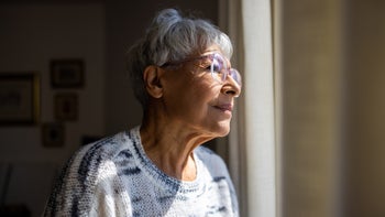 alzheimers-disease: senior woman looking out window 1472634406