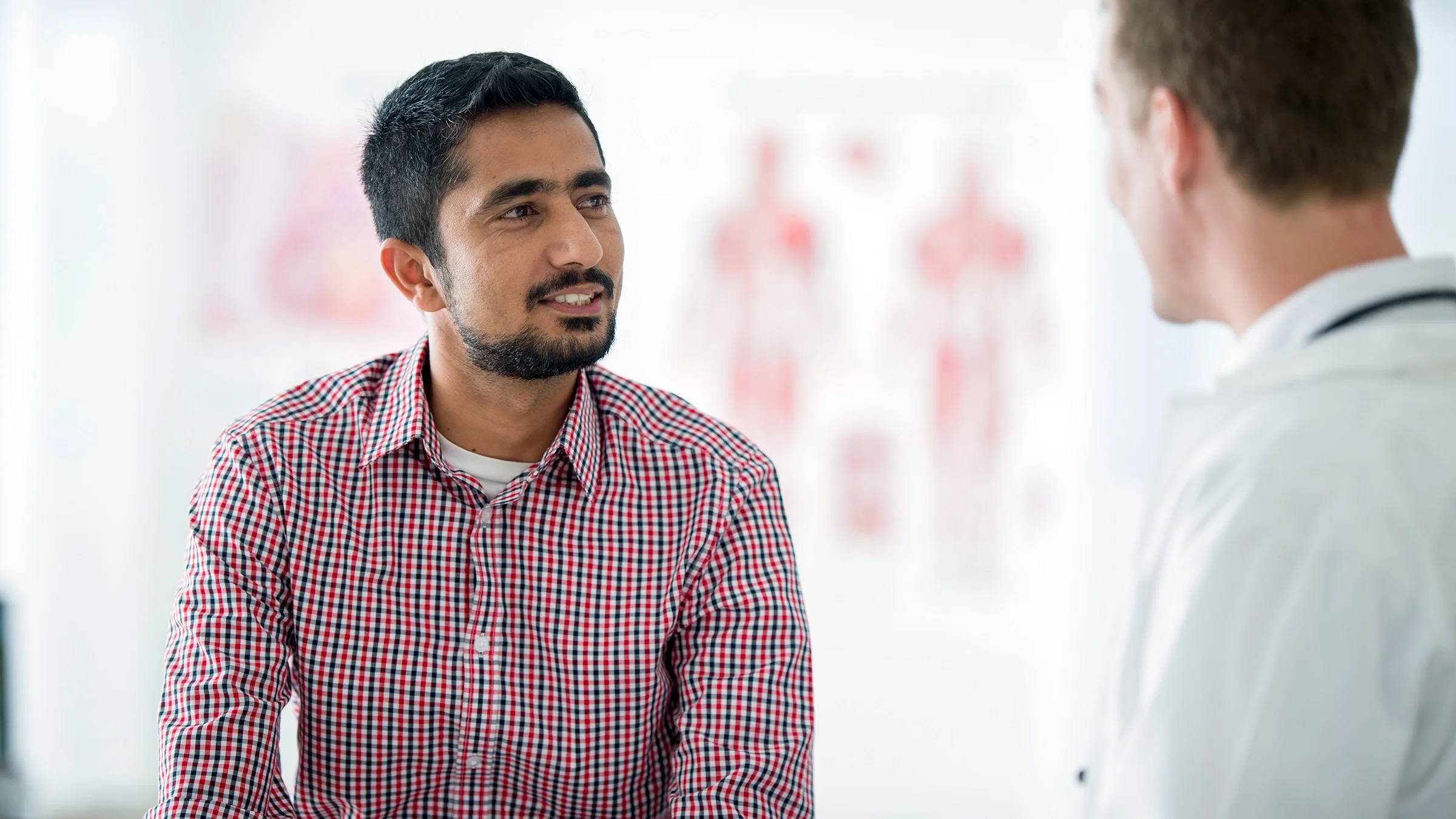 A man is talking with his doctor at an appointment.