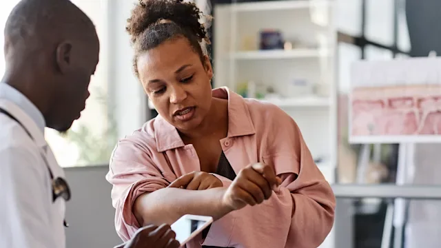 Dermatology: woman at derm appointment 2186297809