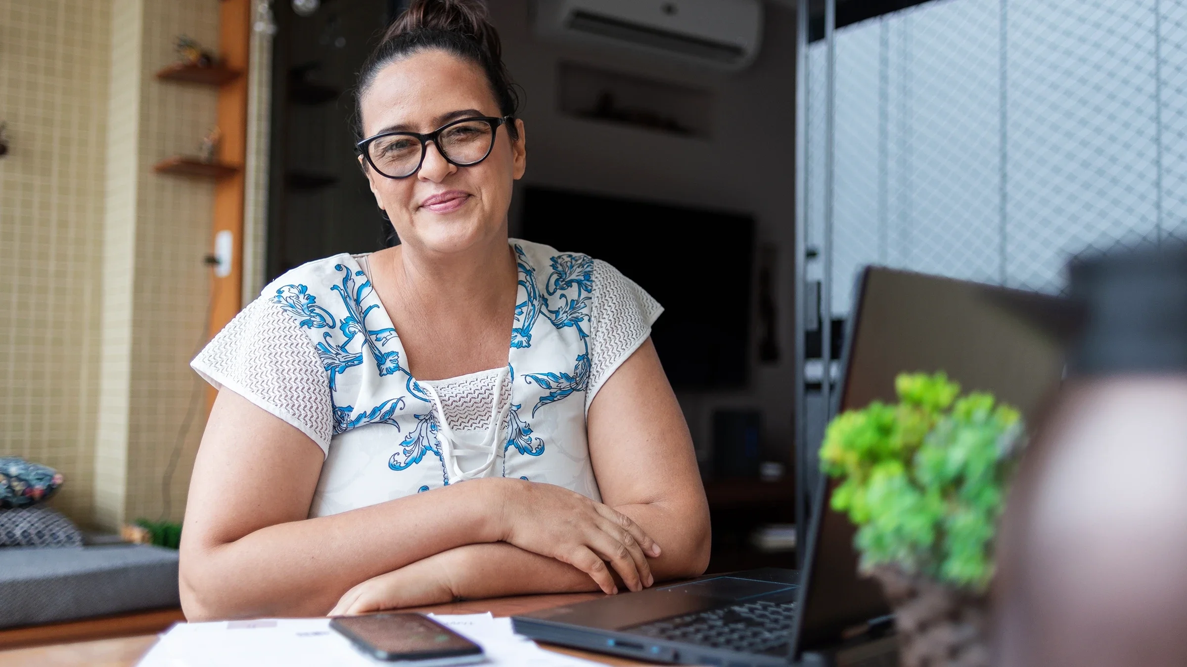 A portrait of a woman doing her finances at home.