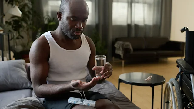 supplements-herbs: man taking medication at home 1401361200