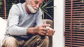 Health: Vemlidy: senior man taking medication-1060805424