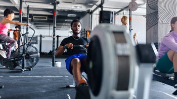 Movement-exercise: man using rowing machine 1497021390