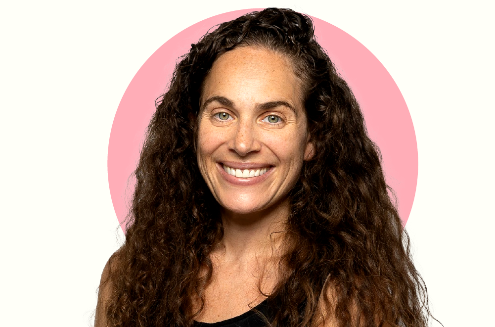 Cutout portrait of Leah Sushesky. There is an added graphic pink circle behind her head.