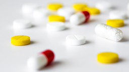 Close-up on various pills on a white background. Some are round and yellow, some are white and yellow, and some are red and white.
Anatoly Kireev/iStock via Getty Images