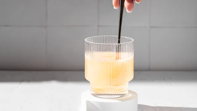 Irritable-bowel-syndrome: closeup mixing powder in glass of water 2168231833