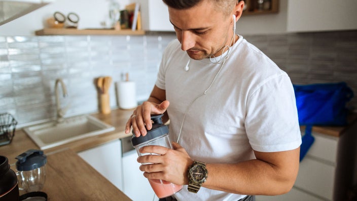 A man making a shake before a workout.
