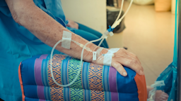 Cropped close-up of someone receiving an IV infusion. 
PongMoji/iStock via Getty Images Plus 