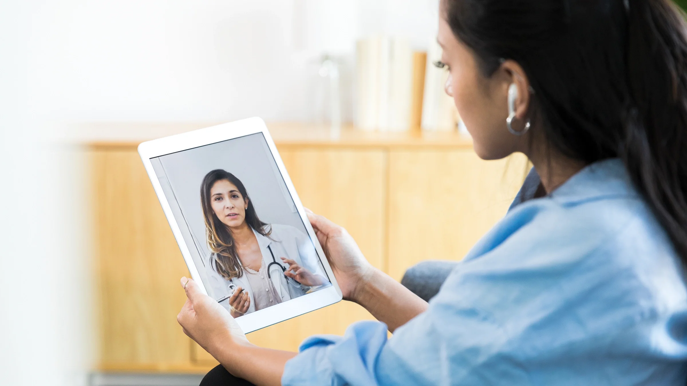 A woman speaks to her healthcare provider during a telemedicine appointment.