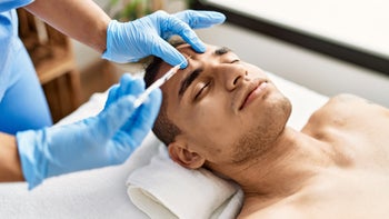 Health: Botox: man getting botox in forehead-1333970176