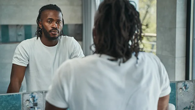 Health: Mens health: man looking at reflection 1354175926