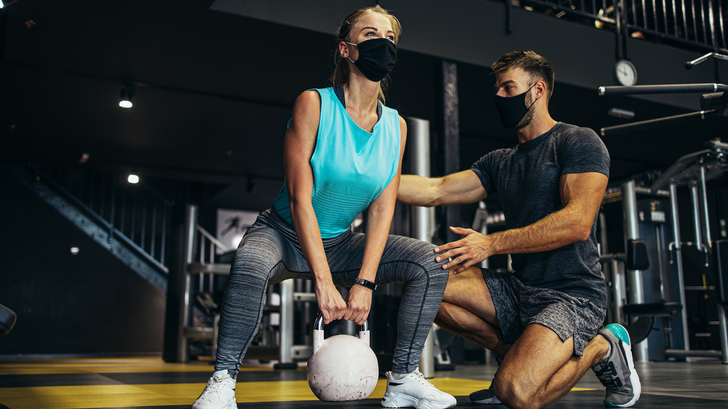 Health: Covid-19: woman working out with kettle bells-1299585149
