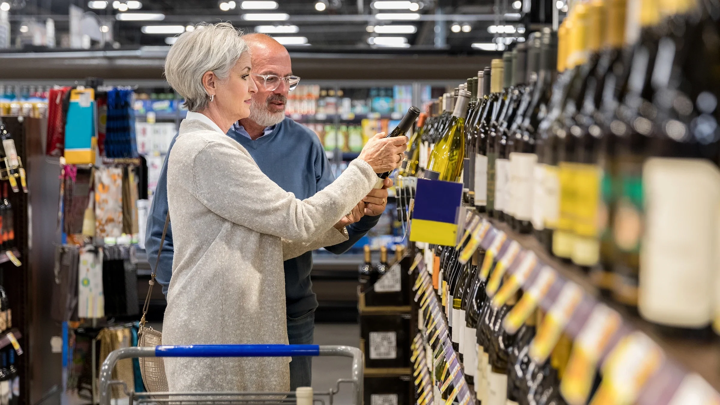 Older couple buying wine.