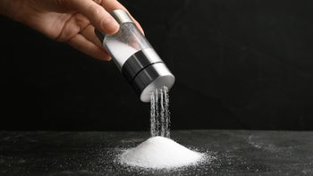 Diet nutrition: closeup hand salt shaker 1374938821