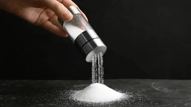 Diet nutrition: closeup hand salt shaker 1374938821