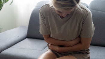 Gastroenterology: woman with abdominal pain 1446745481