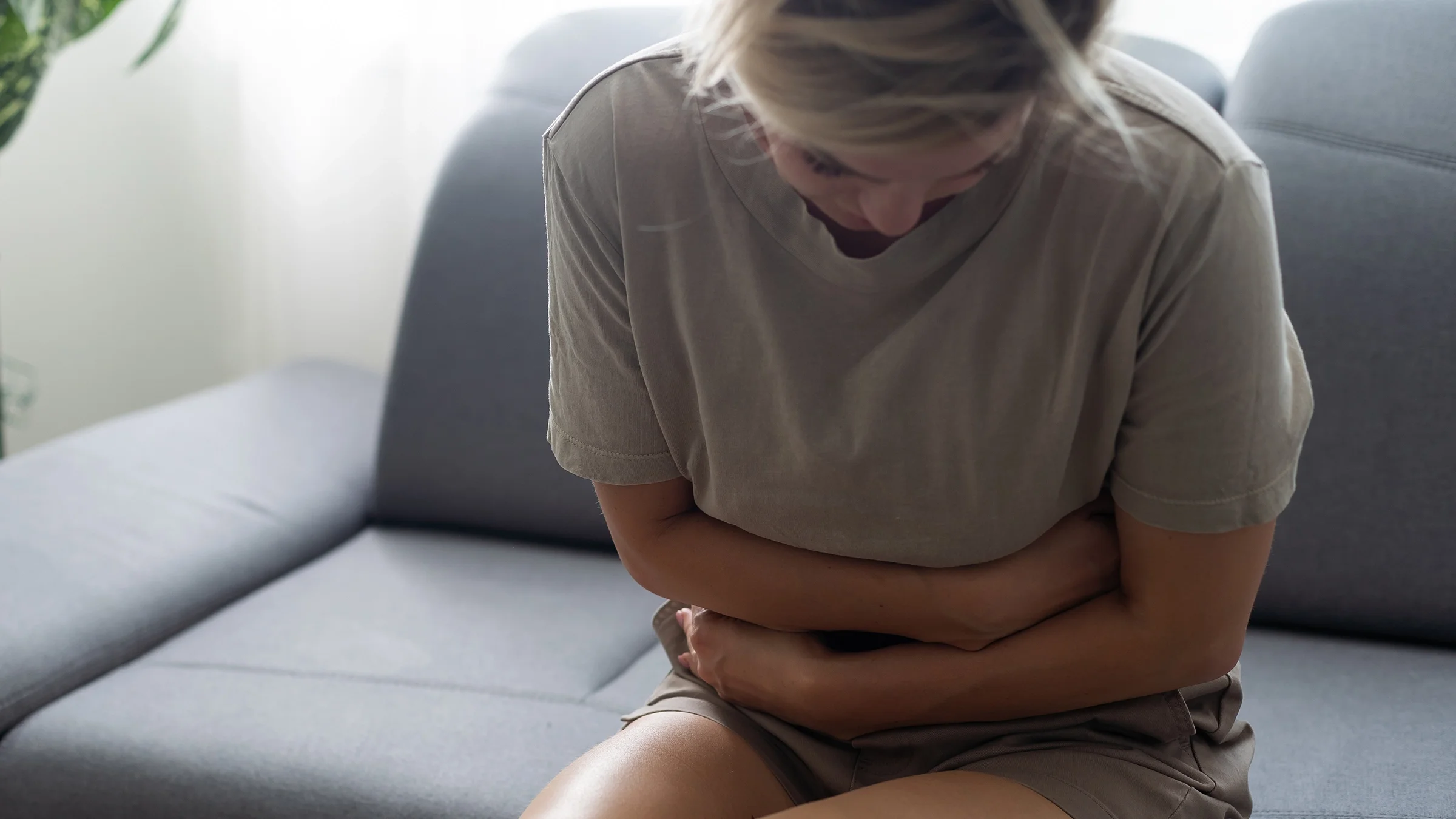 A woman experiences abdominal pain.