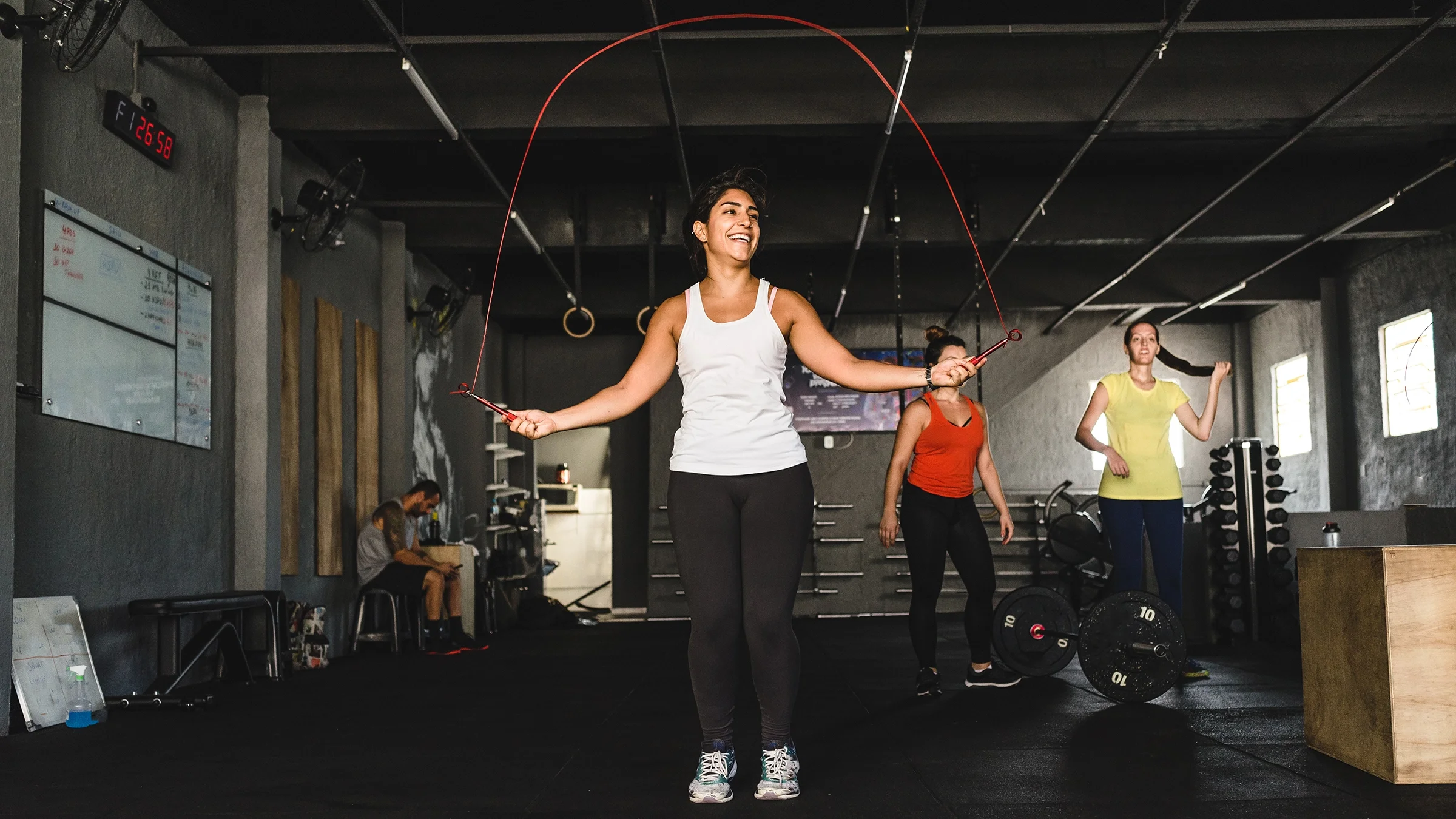 Woman jumping rope in a gym.