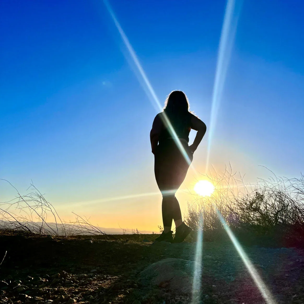 Alyssa Sepulveda is pictured in silhouette on a hike.