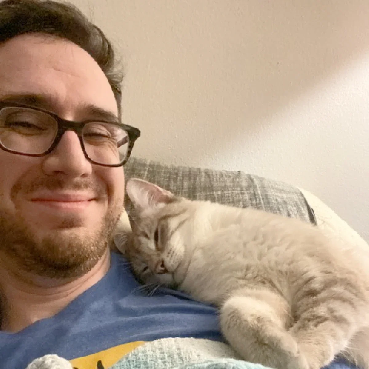 Joey Lusvardi is pictured in a snapshot with Poutine, one of his cats.