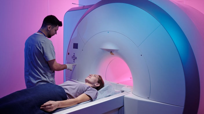 Doctor preparing a female patient for an MRI
