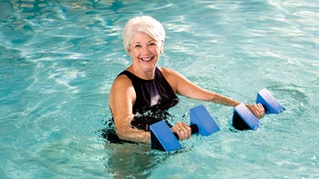 fibromyalgia: senior: pain: exercise: water aerobics woman with white hair-186874700